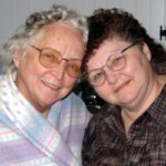 Mother and daughter smiling and posing for photo